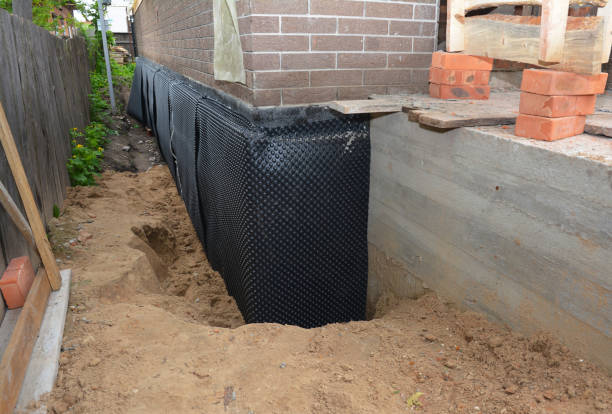Happy homeowners after waterproofing job in Ida